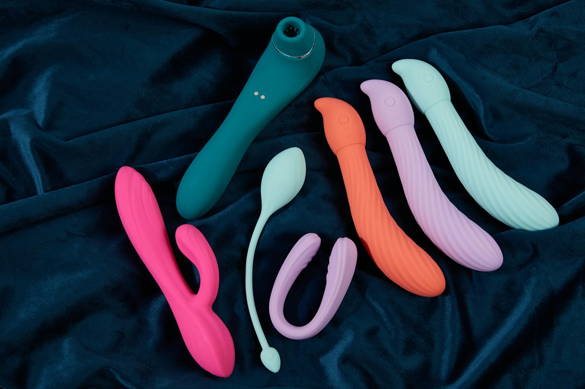 Couple holding a clitoral vibrator together, representing intimacy and connection after childbirth