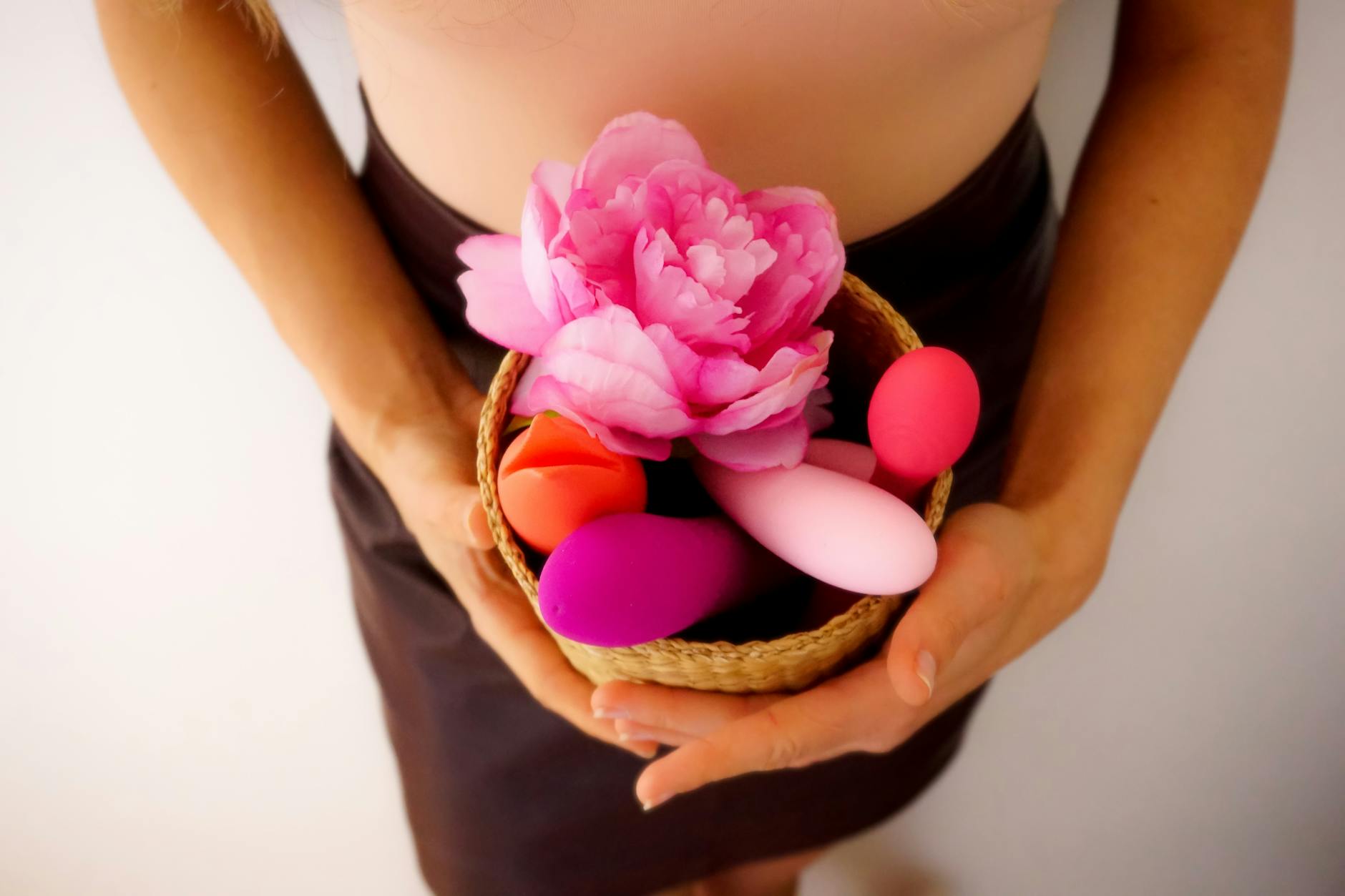 Blue vibrator surrounded by flowers and fresh citrus on a bright background